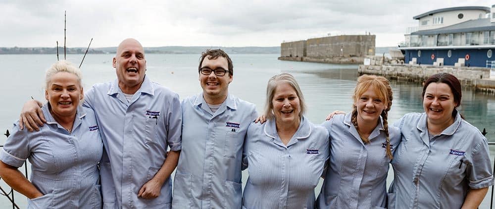 Care staff in front of Portland Harbour