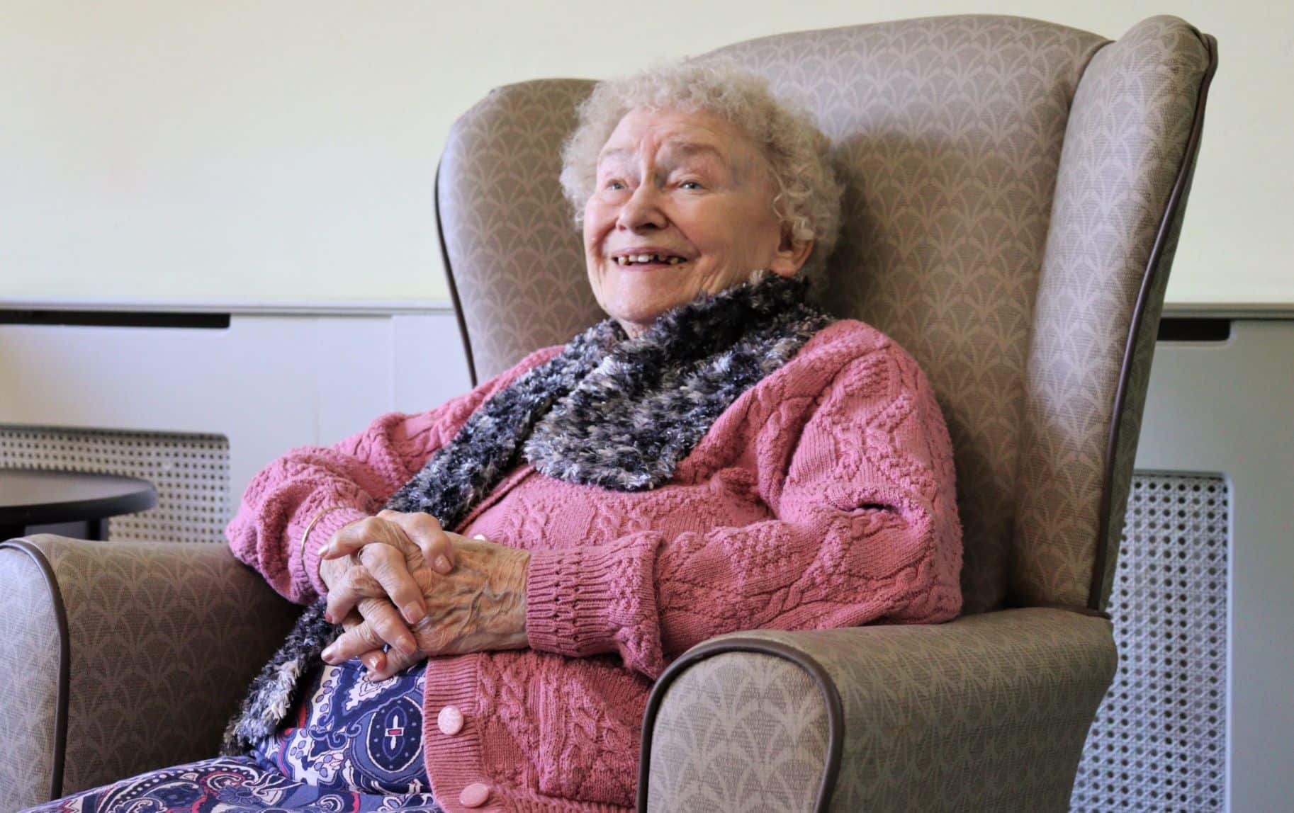 Trafalgar resident Greta laughing in an armchair