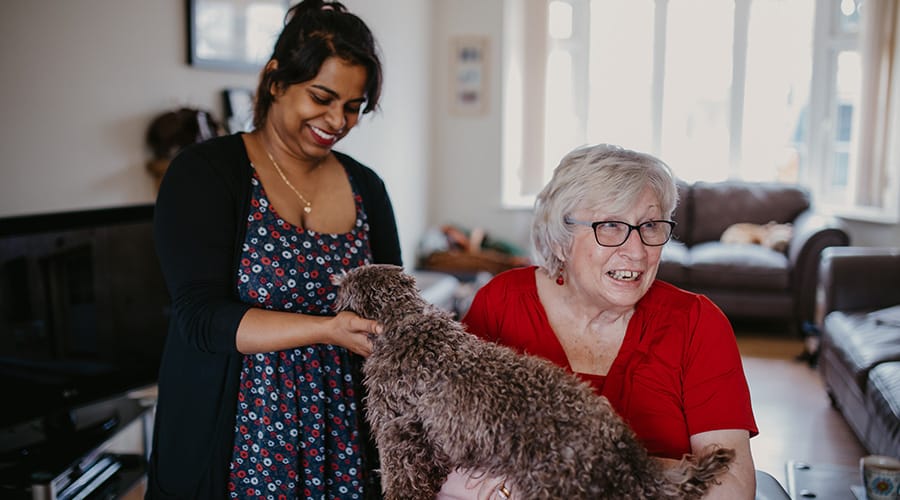 Live in care worker and client with dog