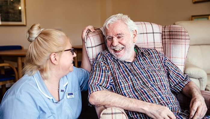 Resident and care worker smiling Gainsborough care home