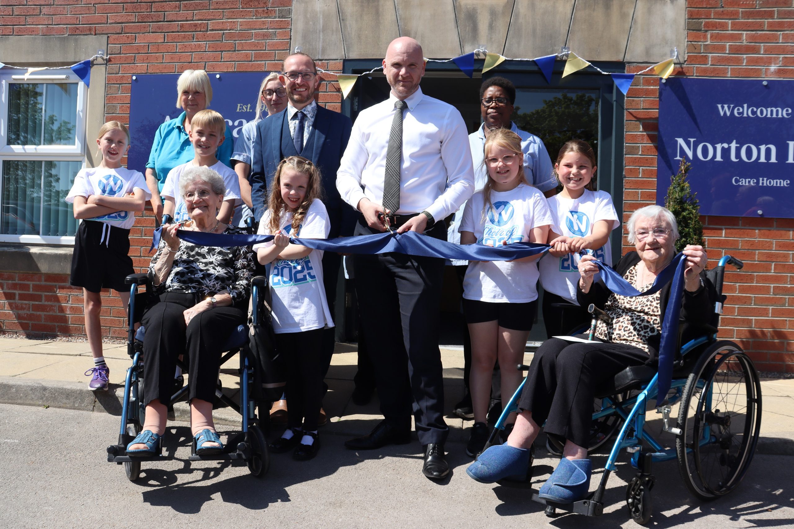 Colour image of a ribbon cuting event at Norton Lees Care Home in Sheffield at its official opening on 9.5.25 featuring residents, staff and Agincare Director Adam Luckhurst
